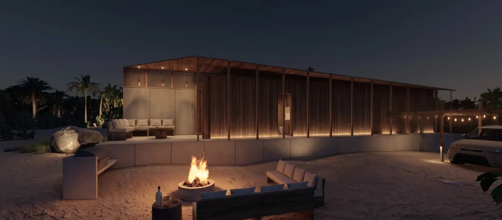 Illuminated Casa Naila pavilion and outdoor seating around a fire pit at night